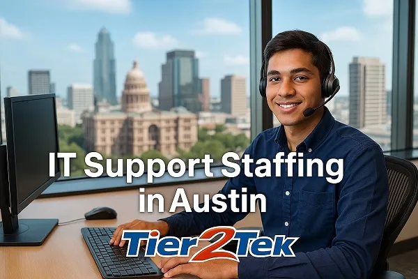 IT support professional at desk with Austin skyline in the background, representing IT staffing services by Tier2Tek Staffing.
