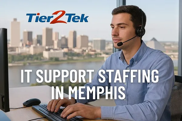 IT support technician at desk with Memphis skyline in the background, representing IT support staffing in Memphis by Tier2Tek Staffing