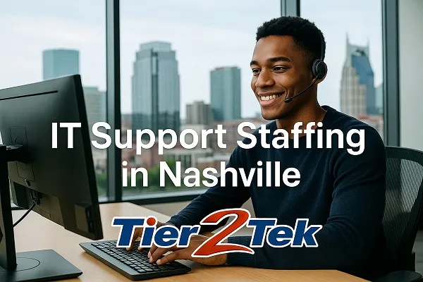 IT support professional at desk with Nashville skyline in background, representing IT staffing services.