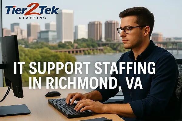 IT support professional at desk overlooking Richmond, VA skyline
