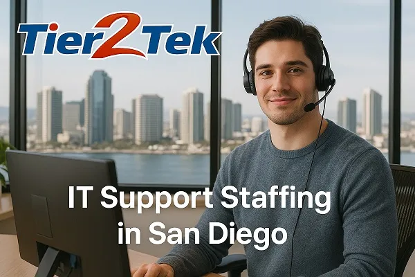 IT support staff member at desk with San Diego skyline in background, representing IT staffing by Tier2Tek Staffing.