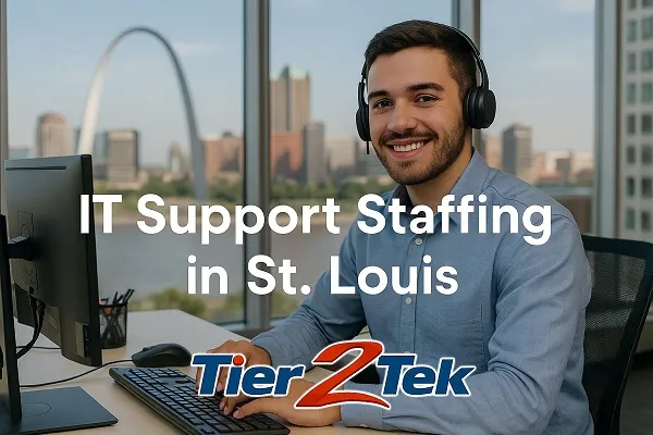 IT support technician at desk with St. Louis skyline in background