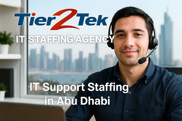 IT support technician at desk with Abu Dhabi skyline in background, representing Tier2Tek Staffing services.